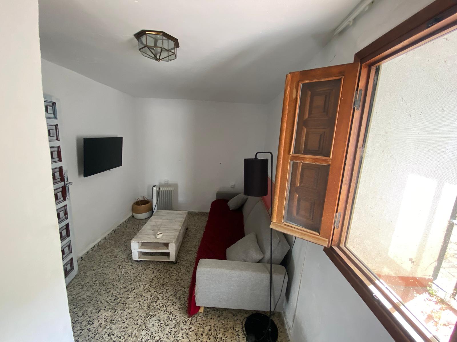 Guest lounge with wall-mounted TV